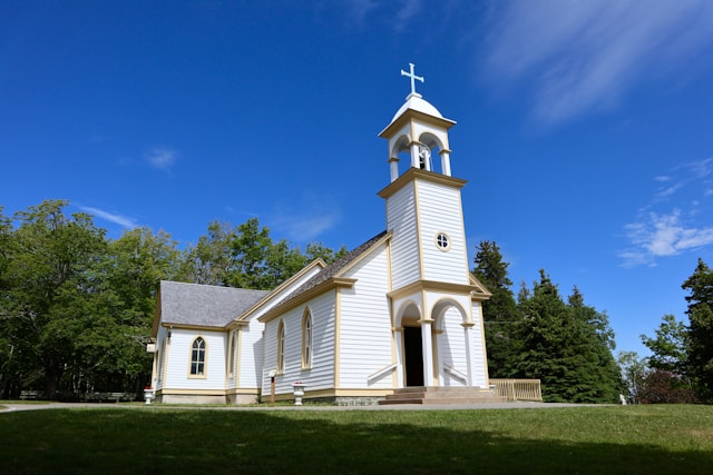 White church with gold trim on blue sky